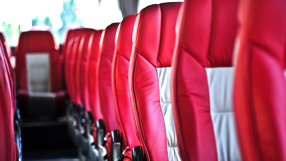 row of red seats on a bus