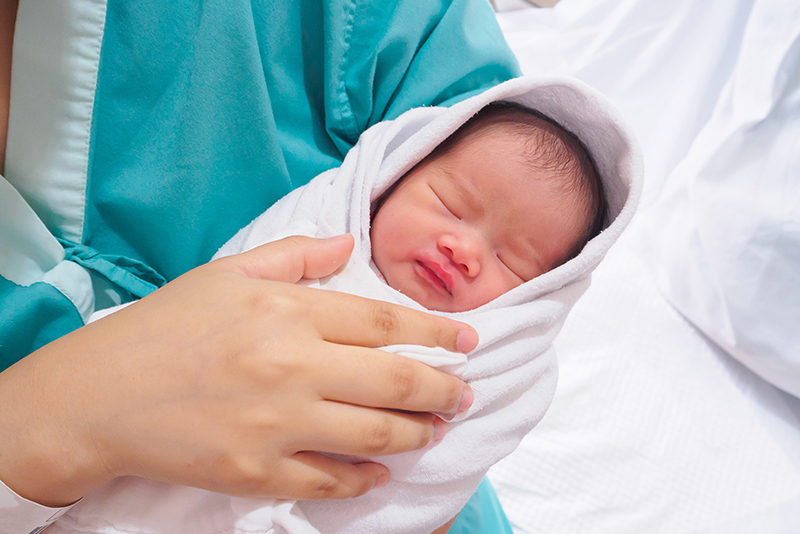 nurse holding a newborn
